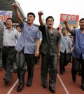 Men pump their fists in the air and chant "Defend!" as they carry propaganda slogans calling for reunification of their country during the "Pyongyang Mass Rally on the Day of the Struggle Against the U.S.," attended by approximately 100,000 North Koreans to mark the 65th anniversary of the outbreak of the Korean War at the Kim Il Sung stadium, Thursday, June 25, 2015, in Pyongyang, North Korea. The month of June in North Korea is known as the "Struggle Against U.S. Imperialism Month" and it's a time for North Koreans to swarm to war museums, mobilize for gatherings denouncing the evils of the United States and join in a general, nationwide whipping up of the anti-American sentiment. The banner at right reads: Issue an Order." (AP Photo/Wong Maye-E)