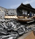 Police rescue team members search through damaged houses to check possibility of trapped people in Mashiki, Kumamoto prefecture, southern Japan, Friday, April 15, 2016. Aftershocks rattled communities in southern Japan as businesses and residents got a fuller look Friday at the widespread damage from an unusually strong overnight earthquake.