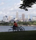 In this July 8, 2014, file photo, a man sits on a picnic table with a view of downtown Cleveland. Forty-two rules govern the Republican Party and how it picks a presidential candidate. Yet with the nomination potentially up for grabs at July’s GOP convention, one reality prevails: Delegates can change their procedures to help or hurt any candidate they want.