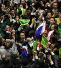 Opposition lawmakers celebrate after the lower house of Congress voted to impeach Brazil's President Dilma Rousseff in the Chamber of Deputies in Brasilia, Brazil, Sunday, April 17, 2016. The measure now goes to the Senate. Rousseff is accused of using accounting tricks in managing the federal budget to maintain spending and shore up support.