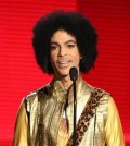 In this Nov. 22, 2015 file photo, Prince presents the award for favorite album - soul/R&B at the American Music Awards in Los Angeles. ABC, NBC, CBS, and CNN, citing unidentified law enforcement sources, reported that prescription painkillers were found on the musician and in his home. The Star Tribune, also citing unnamed sources, reported that prescription pills were found but that it wasn't clear whether they had been prescribed to Prince. Prince was found dead in his Paisley Park home in suburban Minneapolis on April 21, 2016. He was 57.