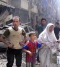 In this image made from video and posted online from Validated UGC, a man leads a woman in tears and child out of the scene after airstrikes hit Aleppo, Syria, Thursday, April 28, 2016. A Syrian monitoring group and a first-responders team say new airstrikes on the rebel-held part of the contested city of Aleppo have killed over a dozen people and brought down at least one residential building. The new violence on Thursday brings the death toll in the past 24-hours in the deeply divided city to at least 61 killed.