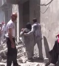 This image made from video released by Qasion News Agency, a media opposition platform that relies on a network of activists on the ground, on Friday, April 29, 2016 shows people scrambling through rubble following airstrikes in Aleppo, Syria. Insurgents shelled a mosque in a government-held neighborhood of Aleppo, killing at least 15 people as they left Friday prayers, while government airstrikes struck rebel-held parts of Syria's largest city — even as the army unilaterally declared a brief truce in other parts of the country.