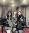 This undated photo provided by Starship Entertainment shows singers Soyou (L) and Baekhyun posing for the camera at a recording studio for their duet song "Rain."