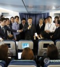 South Korean President Moon Jae-in (holding a mic) speaks to reporters while aboard Air Force One en route to Washington on June 28, 2017, for his summit with U.S. President Donald Trump later in the week. (Yonhap)