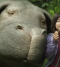 The computer-generated Okja, left, and An Seo Hyun in “Okja.” Credit Netflix