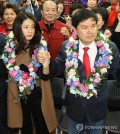 The file photo, taken on April 14, 2016, captures Shim Eun-ha (L), a retired actress, holding hands with her husband Ji Sang-wuk (R), then a candidate for the Saenuri Party, after he won his parliamentary seat in the general elections in Seoul. (Yonhap)