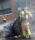 Fire fighters put out a fire in a BMW 520d in Pyeongchang, 180 kilometers east of Seoul, on Sept. 24, 2018, in this photo provided by the car's owner. (Yonhap)