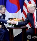 South Korean President Moon Jae-in (L) and U.S. President Donald Trump shake hands after meeting in New York for a bilateral summit on Sept. 24, 2018. (Yonhap)