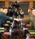 Major Gen. Kim Do-gyun of South Korea (L) shakes hands with North Korea's Lt. Gen. An Ik-san before their talks at the border truce village of Panmunjon on Oct. 26, 2018, in this photo provided by the Joint Press Corps. (Yonhap)