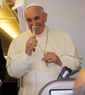 Pope Francis smiles during a press conference aboard a

chartered plane after his visit to South Korea on Aug. 19, 2014. (Yonhap)