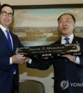 Secretary of the Treasury Steven Mnuchin receives a gift from South Korean Deputy Prime Minister and Finance Minister Hong Nam-ki after a signing ceremony of U.S.- Republic of Korea Framework to Strengthen Infrastructure Finance and Market Building Cooperation, at Treasury Department in Washington, Thursday, Oct. 17, 2019. [AP]