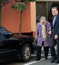 This Dec. 25, 2016, file photo shows President Moon Jae-in and mother Kang Han-ok leaving home to attend a Christmas mass. (Yonhap)