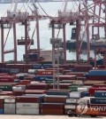 This file photo shows containers carrying export goods in the southeastern city of Busan, South Korea's largest seaport. (Yonhap)