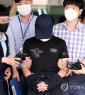 This July 14, 2021, file photo shows a 29-year-old man, surnamed Yang, coming out of Dunsan Police Station in Daejeon, about 165 kilometers south of Seoul, after being investigated on charges of raping and killing a 20-month-old baby girl. (Yonhap)