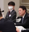 President Yoon Suk Yeol receives a policy briefing from the welfare ministry, labor ministry, gender equality ministry, food and drug safety ministry, and the disease control and prevention agency at Cheong Wa Dae in Seoul on Jan. 9, 2023. (Yonhap)