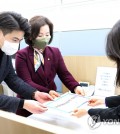 Rep. Oh Yeong-hwan (L) and Rep. Lee Soo-jin (C) of the main opposition Democratic Party submit a penalty motion against Rep. Shin Won-sik of the ruling People Power Party to the National Assembly in Seoul on Jan. 9, 2023. (Pool photo) (Yonhap)