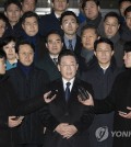 The main opposition Democratic Party leader Lee Jae-myung (C) takes reporters' questions in front of the Seongnam branch of the Suwon District Prosecutors Office in Seongnam, just south of Seoul, in this file photo taken Jan. 10, 2023, after being questioned by prosecutors over bribery allegations. (Pool photo) (Yonhap)