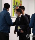 Prosecution officials prepare to enter an office of the Gyeonggi provincial government in Suwon, 34 kilometers south of Seoul, on Feb. 22, 2023, during a raid related to a former Ssangbangwool Group chairman's cash transfers to North Korea. (Yonhap)