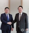 President Yoon Suk Yeol met with Mongolian Prime Minister Luvsannamsrai Oyun-Erdene on Wednesday and agreed to boost cooperation in various sectors, such as rare earth minerals and infrastructure development, his office said. Yoon held the talks with Luvsannamsrai, who is on a five-day official visit to South Korea, at the presidential office in Seoul, presidential spokesperson Lee Do-woon said in a written briefing. During the talks, Yoon said the two sides have expanded ties in various sectors since establishing formal diplomatic relations in 1990. The prime minister delivered a handwritten letter of Mongolian President Ukhnaagiin Khurelsukh expressing the country's support for South Korea's bid to host the World Expo in the southern city of Busan in 2030. In response, Yoon said hosting the expo will not only strengthen people-to-people exchanges, but will result in closer cooperation in various sectors, such as economy, tourism and culture. President Yoon Suk Yeol (R) shakes hands with his Mongolian Prime Minister Luvsannamsrai Oyun-Erdene during their meeting at the presidential office in Seoul on Feb. 15, 2023. (Yonhap) President Yoon Suk Yeol (R) shakes hands with his Mongolian Prime Minister Luvsannamsrai Oyun-Erdene during their meeting at the presidential office in Seoul on Feb. 15, 2023. (Yonhap) Separately, Foreign Minister Park Jin also held talks with his Mongolian counterpart, Batmunkh Battsetseg, who delivered the Mongolian government's support for Seoul's push to host the expo, the foreign ministry said. During their talks at the foreign ministry office in Seoul, Park expressed his thanks for the support, saying the event will serve as an opportunity for the Seoul government to share its vision in climate change response and cooperative development with the international society. The two ministers also shared their push for the establishment of mutually beneficial cooperation in the international arena, such as the United Nations. The talks come nearly six months after Park visited Ulaanbaatar in August. This image, provided by the foreign ministry, shows Foreign Minister Park Jin (R) with his Mongolian counterpart, Batmunkh Battsetseg, on Feb. 15, 2023. (Yonhap) This image, provided by the foreign ministry, shows Foreign Minister Park Jin (R) with his Mongolian counterpart, Batmunkh Battsetseg, on Feb. 15, 2023. (Yonhap)