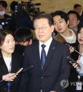 Democratic Party Chairman Lee Jae-myung is surrounded by reporters as he heads to the main hall of the National Assembly building in Seoul on Feb. 27, 2023, ahead of a vote on a motion seeking parliamentary consent to his arrest over corruption charges. (Yonhap)