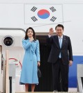 South Korean President Yoon Suk Yeol (R), alongside first lady Kim Keon Hee, waves at Seoul Air Base in Seongnam, south of Seoul, on April 24, 2023, as he embarks on a six-day state visit to the United States. (Yonhap)