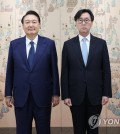 This file photo shows President Yoon Suk Yeol (L) posing with Ambassador to Russia Chang Ho-jin after presenting him with credentials at the presidential office in Seoul on Aug. 12, 2022. (Yonhap)