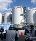 In this file photo, officials at Tokyo Electric Power Company, the operator of the crippled Fukushima nuclear plant, speak to journalists at Fukushima Daiichi Nuclear Power Station on Feb. 2, 2023. (Yonhap)