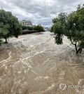 The Gwangju Stream in the southwestern city of Gwangju is flooded due to heavy rains on June 28, 2023. (Yonhap)