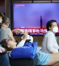 Passengers wait for their train in front of a TV broadcasting a news report on North Korea firing a ballistic missile off its east coast, at a railway station in Seoul, South Korea, July 12, 2023. REUTERS/Kim Hong-Ji