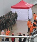 The government launched an inspection into what went wrong in the response to the recent deadly flooding of an underground roadway in the central town of Osong, which has claimed 13 lives, a government office said Monday. The underground roadway in western Cheongju, located 112 kilometers southeast of Seoul, was flooded Saturday morning when the nearby Miho River overflowed after an embankment was brought down by rising water levels due to heavy rain, leaving at least 16 vehicles, including a bus, trapped under water. Rescuers pulled four more bodies from the flood-hit underground tunnel overnight, bringing the death toll to 13. Casualties could rise as rescuers continue an operation to drain and search the underpass. The Office for Government Policy Coordination said it has undertaken an inspection aimed at discovering the causes behind the deadly flooding. The inspection aims to determine "the reasons why the precious lives of people could not be protected," the office said, adding all related government agencies will be subject to scrutiny. The office also said all necessary actions will be taken against those found responsible, including disciplinary action, referral for criminal investigation or system reforms. Earlier in the day, police also said they plan to form a special investigation unit to be in charge of the case to look into why a traffic restriction was not imposed for the underpass despite prior flood warnings issued for the nearby river and whether the embankments alongside the Miho River have been properly managed. Rescuers and military personnel stand ready for a search operation on July 17, 2023, at an underground roadway in the central town of Osong where flooding caused by heavy rain claimed 13 lives. (Yonhap) Rescuers and military personnel stand ready for a search operation on July 17, 2023, at an underground roadway in the central town of Osong where flooding caused by heavy rain claimed 13 lives. (Yonhap) The office said it has confirmed that there were two emergency calls requesting a traffic restriction for the underpass in the two hours prior to the deadly flooding. Officials began the inspection by seizing documents to look into whether there were other emergency reports filed with the regional government, police or fire offices and what action the offices had taken in response. The office also plans to scrutinize what advance safety measures were taken by such regional offices to illuminate why a timely traffic restriction was not imposed around the underpass.