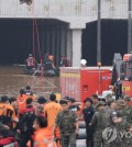 A search operation is under way on July 16, 2023, in a flooded underground tunnel in the central town of Osong. (Yonhap)