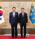 President Yoon Suk Yeol (L) poses for a photo with new Unification Minister Kim Yung-ho after presenting him a letter of appointment at the presidential office in Seoul on July 28, 2023. (Pool photo) (Yonhap)