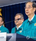 Prime Minister Han Duck-soo (R) makes a public speech at the government complex in Seoul on Aug. 23, 2023. (Yonhap)