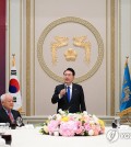 President Yoon Suk Yeol (C) gives remarks during a dinner with members of the Presidential Committee of National Cohesion at Cheong Wa Dae in Seoul on Oct. 17, 2023, in this photo provided by the presidential office. On the right is People Power Party leader Kim Gi-hyeon. (PHOTO NOT FOR SALE) (Yonhap)