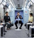 President Yoon Suk Yeol (C) speaks during a public meeting over intercity transport on a train at Dongtan Station in Hwaseong, 45 kilometers south of Seoul, on Nov. 6, 2023. (Pool photo) (Yonhap)