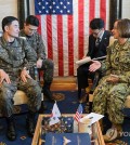 Adm. Yang Yong-mo (L), chief of naval operations, holds talks with his U.S. counterpart, Adm. Lisa Franchetti, aboard USS Carl Vinson berthed at a naval base in Busan, 320 kilometers southeast of Seoul, on Nov. 24, 2023, in this photo provided by South Korea's Navy. (PHOTO NOT FOR SALE) (Yonhap)