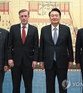 This photo, provided by the presidential office, shows President Yoon Suk Yeol (2nd from R), National Security Adviser Cho Tae-yong (L), U.S. National Security Advisor Jake Sullivan (2nd from L) and Japan's National Security Secretariat Secretary General Takeo Akiba ahead of their dinner meeting at the presidential residence in Seoul on Dec. 8, 2023. (PHOTO NOT FOR SALE) (Yonhap)