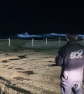 Firefighters in Gangneung, Gangwon Province, inspect a beach by the East Sea on Jan. 1, 2024, as a major earthquake off Japan's west coast caused minor tsunamis in waters off the South Korean east coast. (Yonhap)