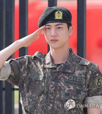BTS member Jin salutes at the main gate of the 5th Army Infantry Division in Yeoncheon, 61 kilometers north of Seoul, on June 12, 2024, after completing his mandatory military service. (Yonhap)