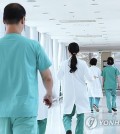 Doctors walk at a general hospital in Seoul in this photo taken June 10, 2024. (Yonhap)