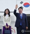 President Yoon Suk Yeol (R) and first lady Kim Keon Hee bid farewell while boarding the presidential plane at Noi Bai International Airport in Hanoi, in this file photo taken June 24, 2023, after a three-day state visit to Vietnam. (Yonhap)