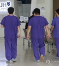 Doctors walk at Seoul National University Hospital in Seoul on June 6, 2024. (Yonhap)