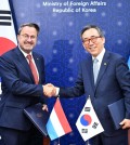Foreign Minister Cho Tae-yul (R) poses with Luxembourg's Deputy Prime Minister and Foreign Minister Xavier Bettel after signing a memorandum of understanding on a working holiday program, ahead of their bilateral talks at Seoul's foreign ministry on July 3, 2024, as provided by Cho's office. (PHOTO NOT FOR SALE) (Yonhap)