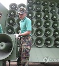 This file photo shows loudspeakers being taken down at a western front-line unit in June 2004. (Yonhap)