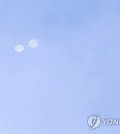 A presumed trash-carrying balloon from North Korea floats over Yongsan Ward, the district where the presidential office is located, in Seoul on July 24, 2024. (Yonhap)