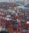 In this file photo, shipping containers are stacked at a pier in South Korea's southeastern port city of Busan on Jan. 1, 2024. (Yonhap)