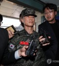 In this file photo, Lim Seong-geun (C), former commander of the Marine Corps 1st Division, appears for police questioning in Gyeongsan, 250 kilometers southeast of Seoul, on May 14, 2024. (Yonhap)