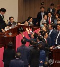 Lawmakers of the People Power Party (PPP) protest against National Assembly Speaker Woo Won-shik (L) after Woo asks them to end their filibuster at a plenary session on July 4, 2024. (Yonhap)