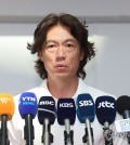 Hong Myung-bo, head coach of the South Korean men's national football team, speaks to reporters at Incheon International Airport, west of Seoul, on July 15, 2024, before traveling to Europe to interview candidates for his assistant coaching positions. (Yonhap)